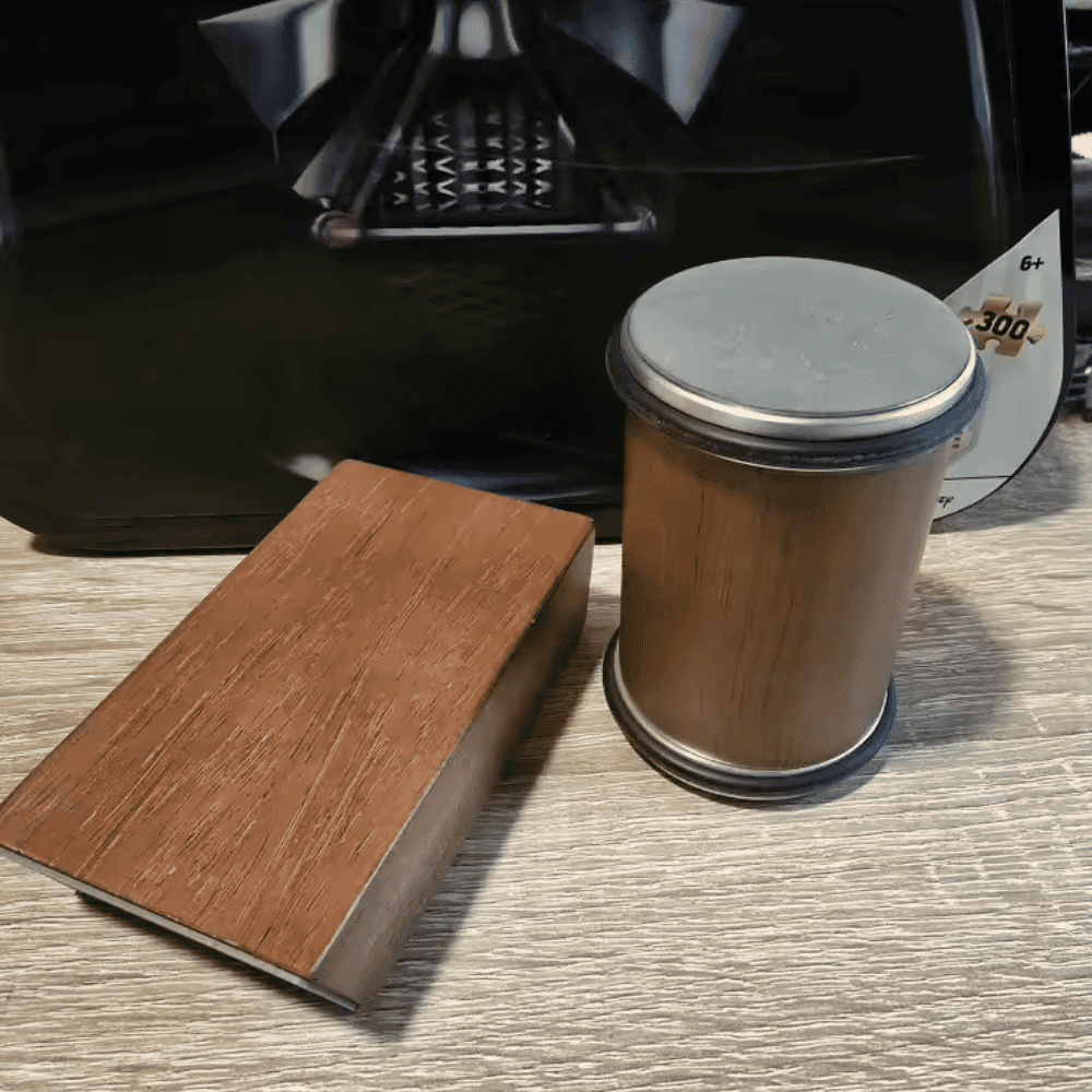 Wooden coaster and cylindrical wooden product on a textured surface with a blurred background